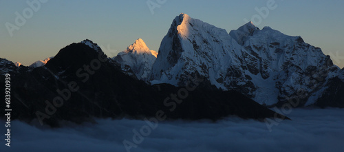 Sun lit peak of Mount Ama Dablam and Cholatse at sunset, Nepal.