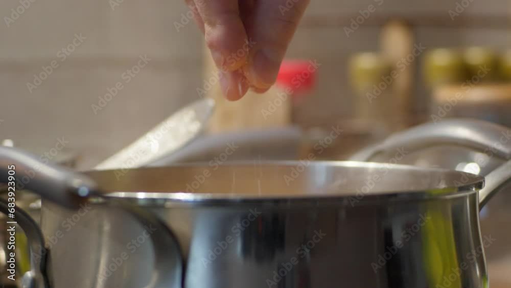 Adding salt to a pot of food close-up. Homemade food Adding salt to a pot of food close-up. Homemade food