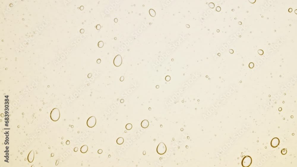 Transparent cosmetic gel fluid with molecule bubbles oil distribution on a white background. Macro Shot of Natural Organic Cosmetics, Medicine. Production Close-up. Slow Motion. High quality 4k Transparent cosmetic gel fluid with molecule bubbles oil distribution on a white background. Macro Shot of Natural Organic Cosmetics, Medicine. Production Close-up. Slow Motion. High quality 4k