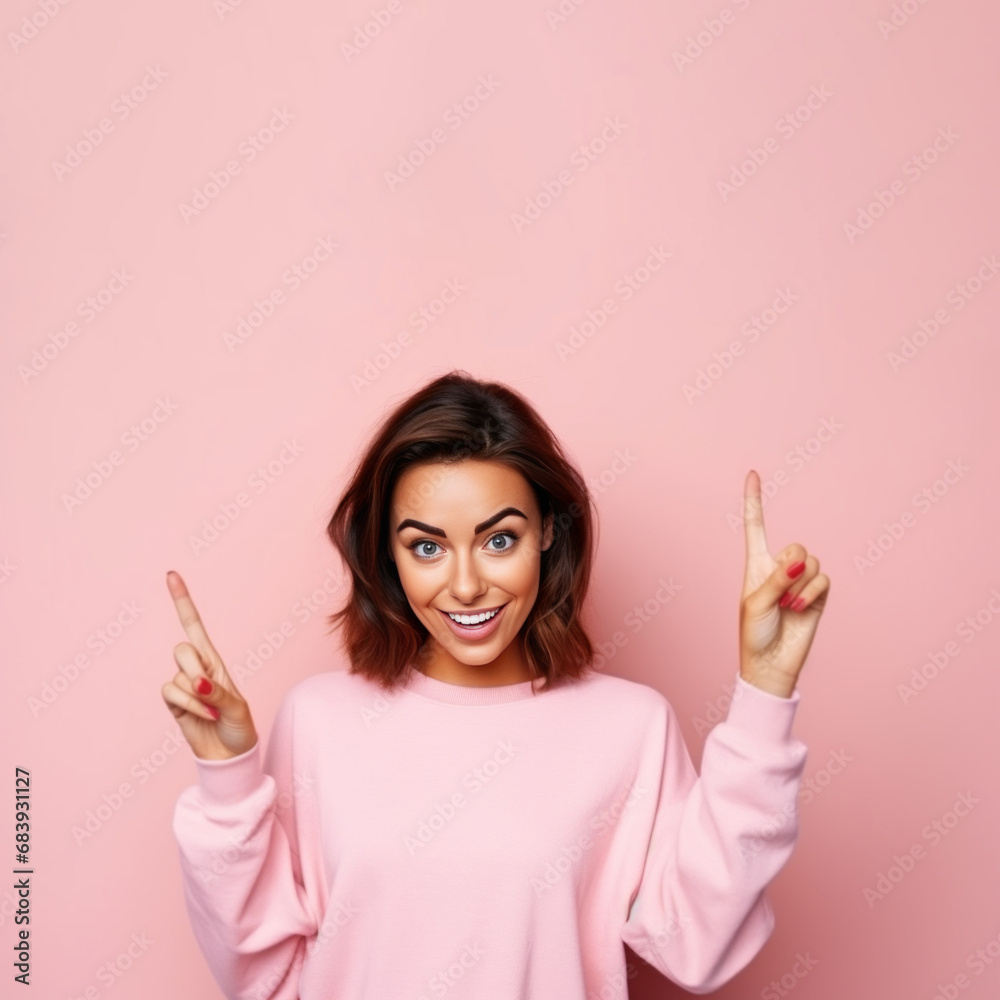 Young woman smiling and pointing fingerto empty copy space standing isolated on pink background, Young woman smiling and pointing fingerto empty copy space standing isolated on pink background,
