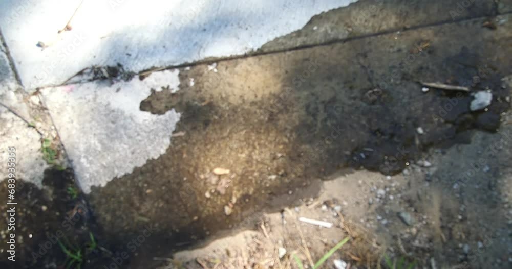 Water flows on a sidewalk from a fire Water flows on a sidewalk from a fire
