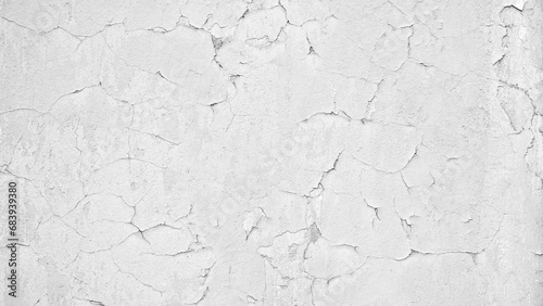 white wall with cracked paint as a textured abstract background for a page, template or web banner