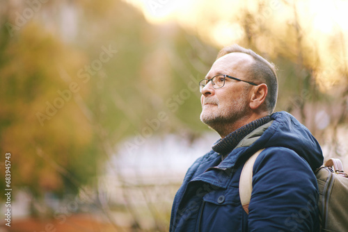 Outdoor portrait of handsome  mature man enjoying nice day outside, fall season