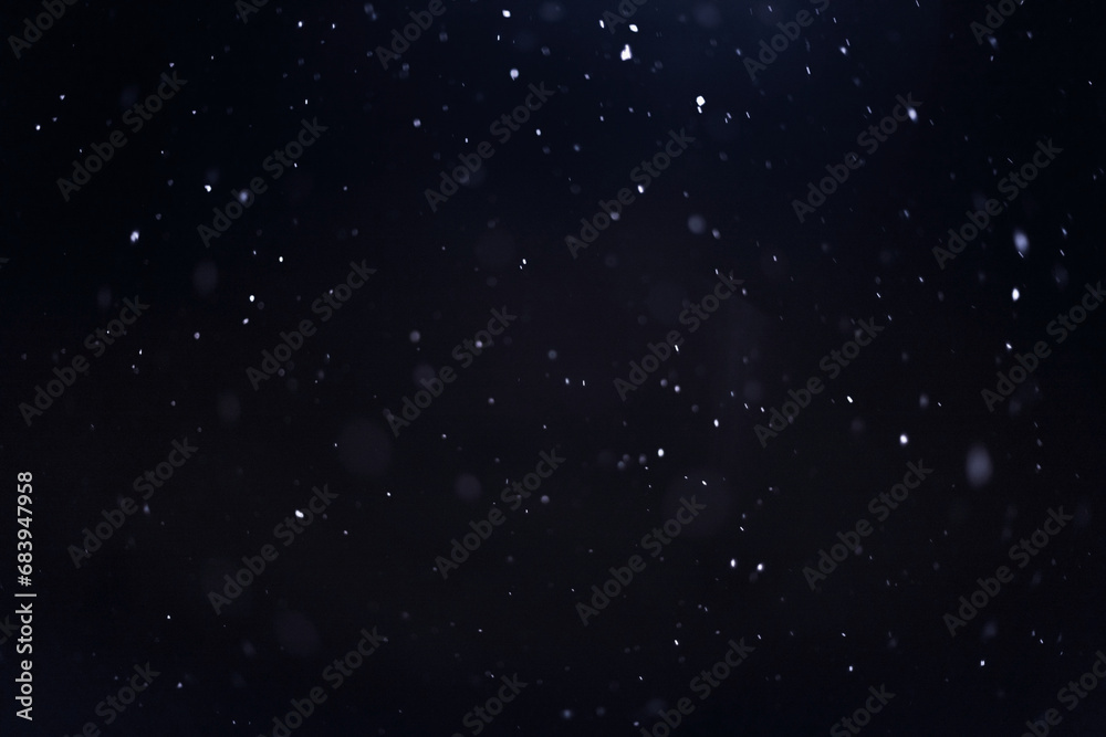 falling snow on a dark background, winter snowy background for design and overlay