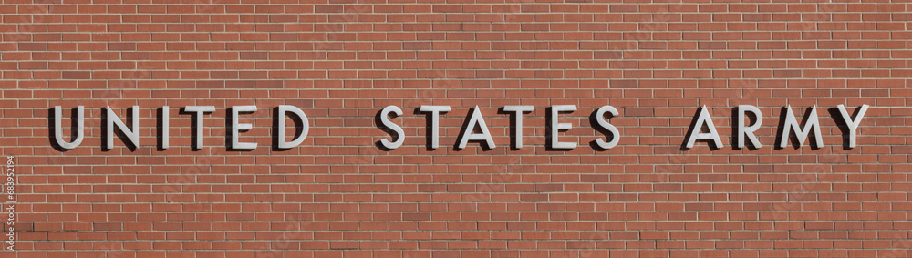 Obraz premium UNITED STATES ARMY banner in stainless steel text against a brick background. The Army is a branch of the US military.