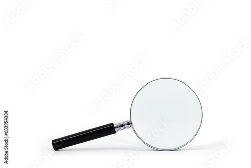 A photo featuring a magnifying glass with a black handle and a silver rim around the magnifying glass, captured against a white background.