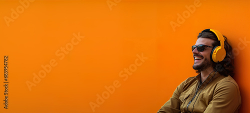 Young man listening to music with orange background. AI Generated