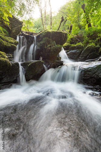 Fototapeta Naklejka Na Ścianę i Meble -  Long exposure of a waterfall on the Hoar Oak Water river at Watersmeet in Exmoor National Park