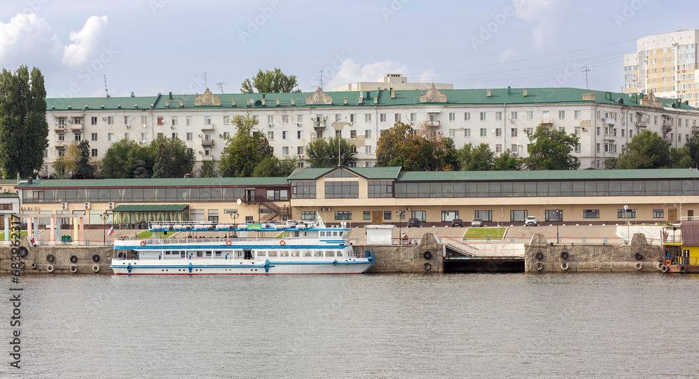 Saratov embankment with a pier and a white ship on the Volga in summer
