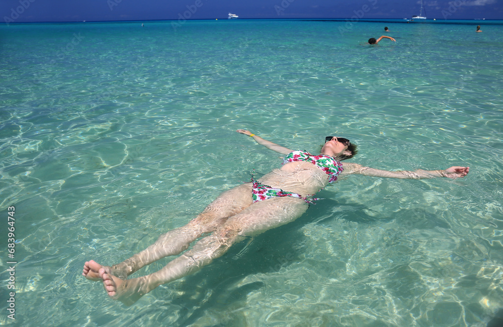 woman enjoing holidays in a turquoise water beach in mallorca