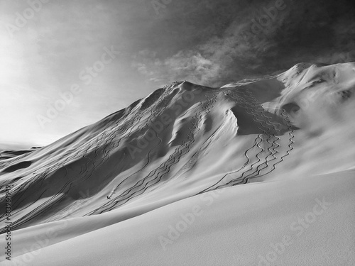 Backcountry skier riding from girenspitz St.Antönien. Backcountry tour in powder snow. Great deep snow freeride from the summit. Black & White photo. High quality photo photo