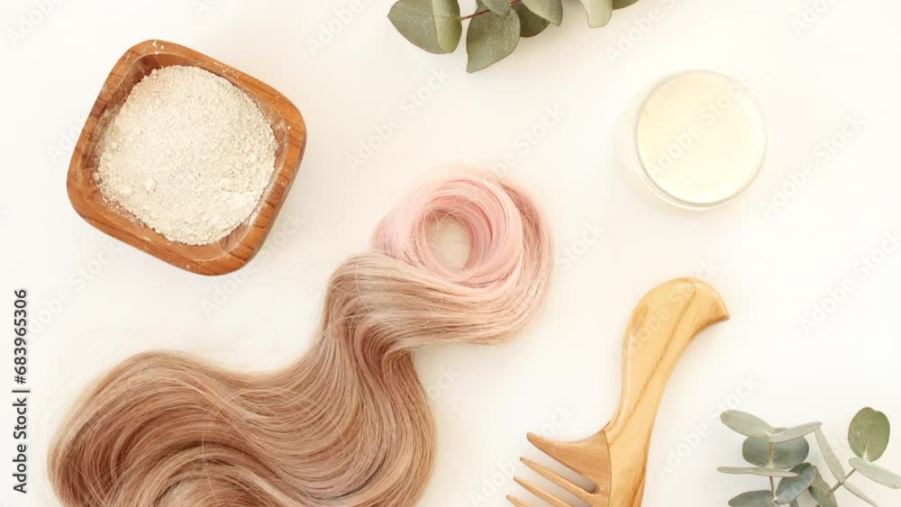 Blond shiny wavy hair on white background. Shiny woman hair strand, curl. Hair care and beauty salon. Natural cosmetic products. Hair color palette. High quality 4k footage