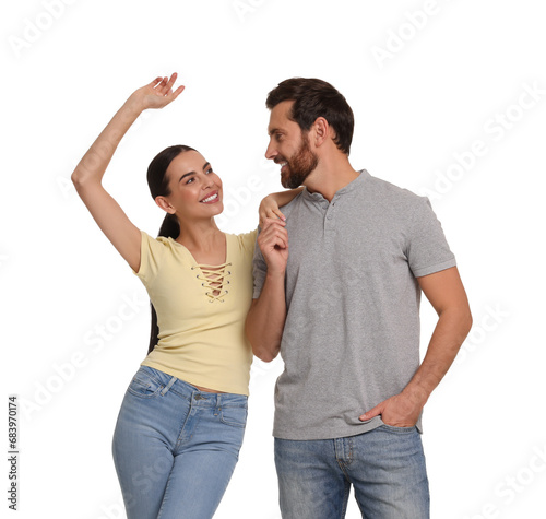 Happy couple dancing together on white background