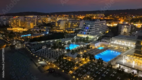 Aerial night view of luxury hotels and resorts in Protaras, Cyprus. Beachfront resorts on Mediterranean Sea. Nightlife in summer Cyprus  photo