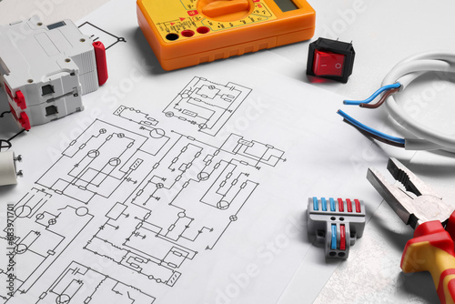 Wiring diagrams and different electrician's equipment on white table