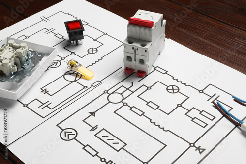 Wiring diagrams and different electrician s equipment on wooden table