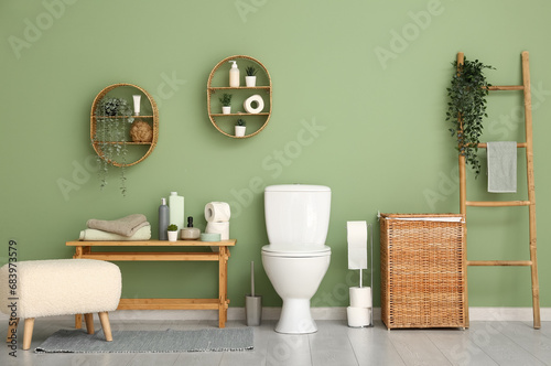 Stylish interior of modern restroom with wicker laundry basket photo