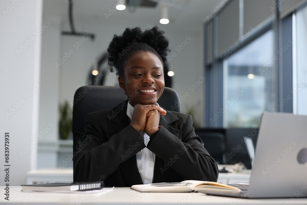 Happy woman working at table in office. Lawyer, businesswoman, accountant or manager Happy woman working at table in office. Lawyer, businesswoman, accountant or manager