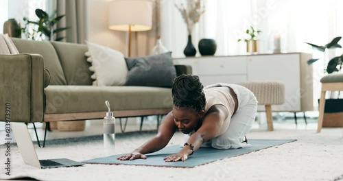 Yoga, laptop or black woman stretching in home or house studio for wellness, peace or balance. Pilates, online tutorial or African person in cat pose for energy training, spine or holistic exercise photo
