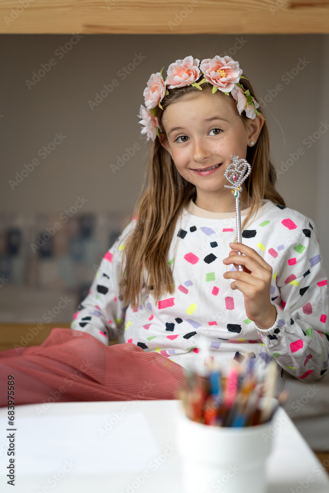 happy little girl in her play room making fun toy colours laugh