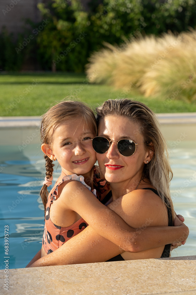 happy daughter and mom enjoy summer fun at the pool blue water happy love