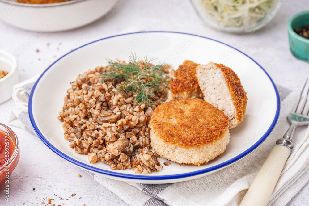 Plate of tasty meat cutlets with buckwheat on white background Plate of tasty meat cutlets with buckwheat on white background