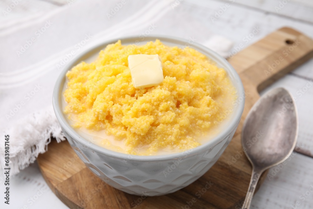 Tasty cornmeal with butter in bowl served on table, closeup Tasty cornmeal with butter in bowl served on table, closeup