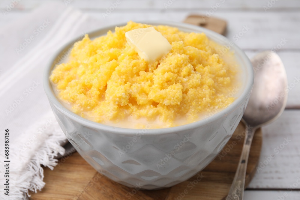 Tasty cornmeal with butter in bowl served on table, closeup Tasty cornmeal with butter in bowl served on table, closeup