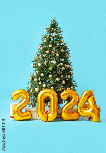 Figure 2024 made of foil balloons, Christmas tree and gift boxes on color background