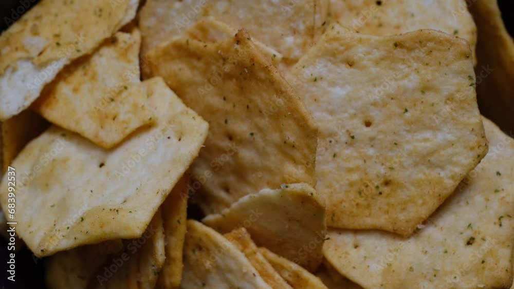 Homemade chips with spices rotate 360 degrees in purple bowl, 4k resolution Homemade chips with spices rotate 360 degrees in purple bowl, 4k resolution