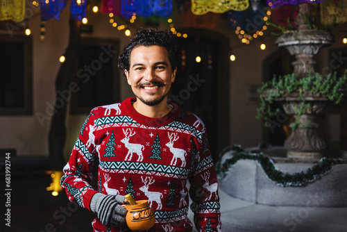 Latin man at traditional posada party for Christmas celebration in Mexico Latin America, holidays and Christmas eve photo