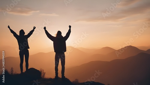 silhouette of a people with arms raised up to the sky  standing on a mountain  symbolic success  success concept