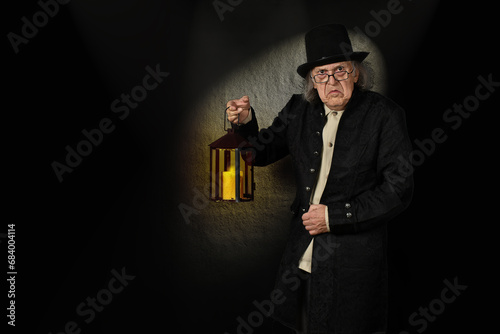 Scrooge with a lantern, in front of a one-spot background