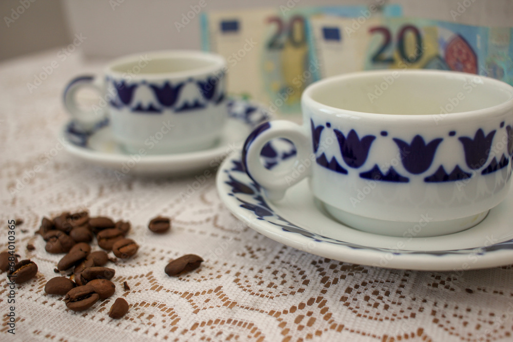 grains of coffee and two cups of coffee grains of coffee and two cups of coffee