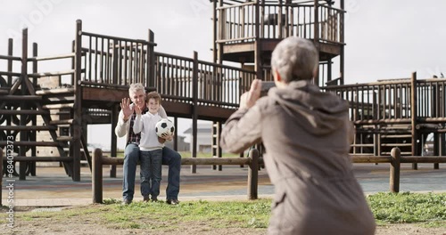 Happy, photograph and a grandparents at the park with their grandchild for a sports memory together. Family, phone or wave and a boy kid at the playground with his senior grandmother and grandfather photo