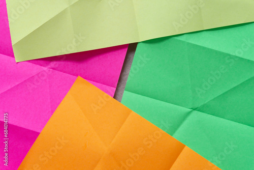 neon paper with crease marks partly layered on one another