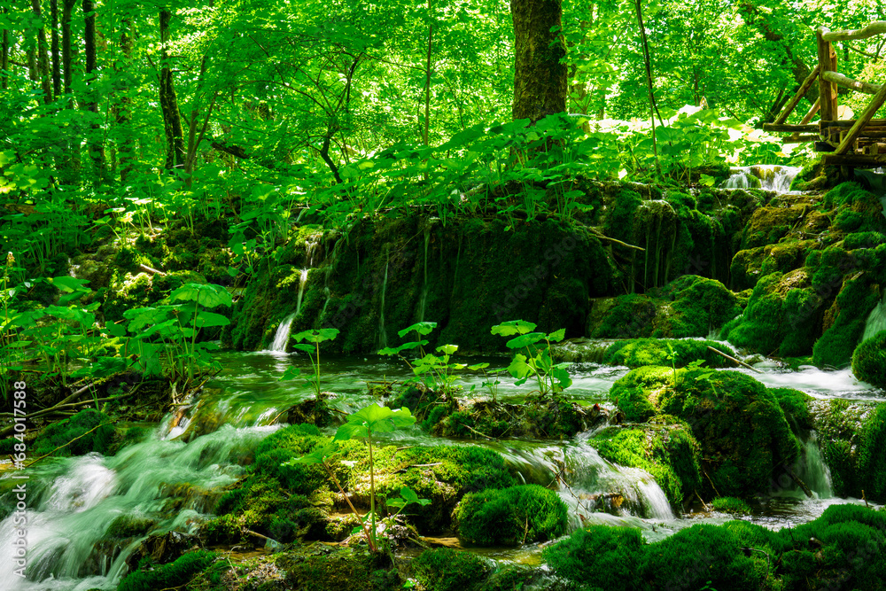Fototapeta premium A breathtaking view of the stunning waterfalls in Krka National Park, Croatia. The cascading waters creating a mesmerizing natural wonder amidst lush greenery.