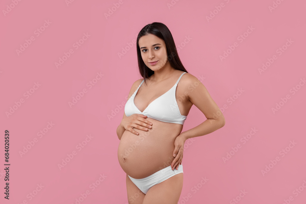 Beautiful pregnant woman in stylish comfortable underwear on pink background Beautiful pregnant woman in stylish comfortable underwear on pink background