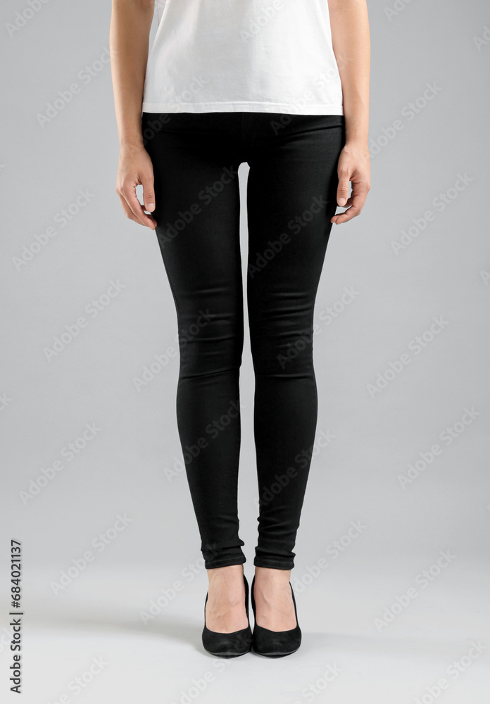 Woman wearing stylish black jeans and high heels shoes on light gray background, closeup Woman wearing stylish black jeans and high heels shoes on light gray background, closeup
