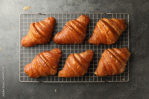 Delicious fresh croissants on grey table, top view