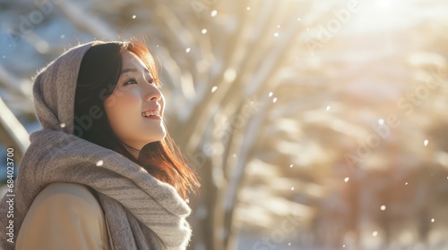 A Side view  beautiful Asian woman smiling  throwing snow into the air  on a sunny winter day  wearing a beanie and scarf  snow-covered pine forest background  warm sunlight.