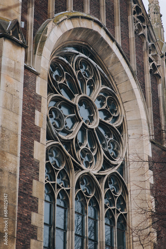 Old openwork round window with stained glass on facade of the building. Baroque and Gothic architecture. Church of St. Olga and Elizabeth. Lviv  Ukraine.