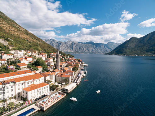 Swimming pool and private beach on the shore of the Bay of Kotor overlooking ancient houses. Perast  Montenegro. Drone