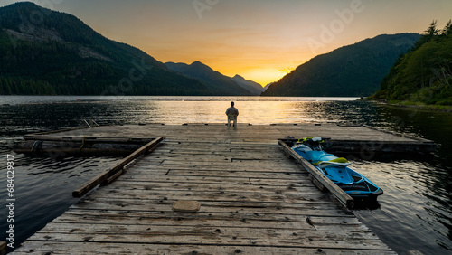 Sitting out on the dock, enjoying the sunset at Muchalat Lake recreation site on Vancouver Island, British Columbia, Canada