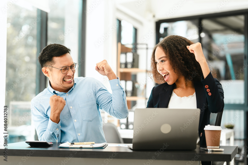 Asian business man and African American woman engaging in business discussion, possibly about merger or joint venture. two companies become one, one of companies often survives while other disappears