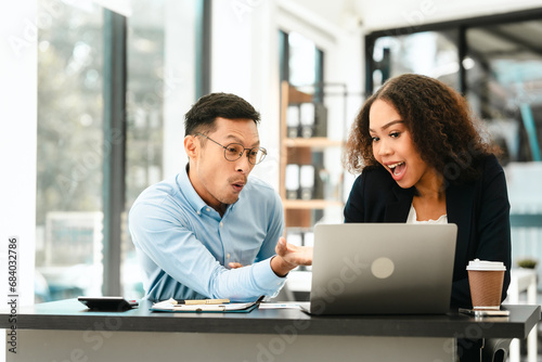 Wallpaper Mural Asian business man and African American woman engaging in business discussion, possibly about merger or joint venture. two companies become one, one of companies often survives while other disappears Torontodigital.ca