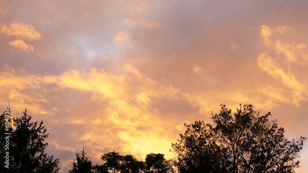 The beautiful sunset view with the colorful clouds and warm sunlight
