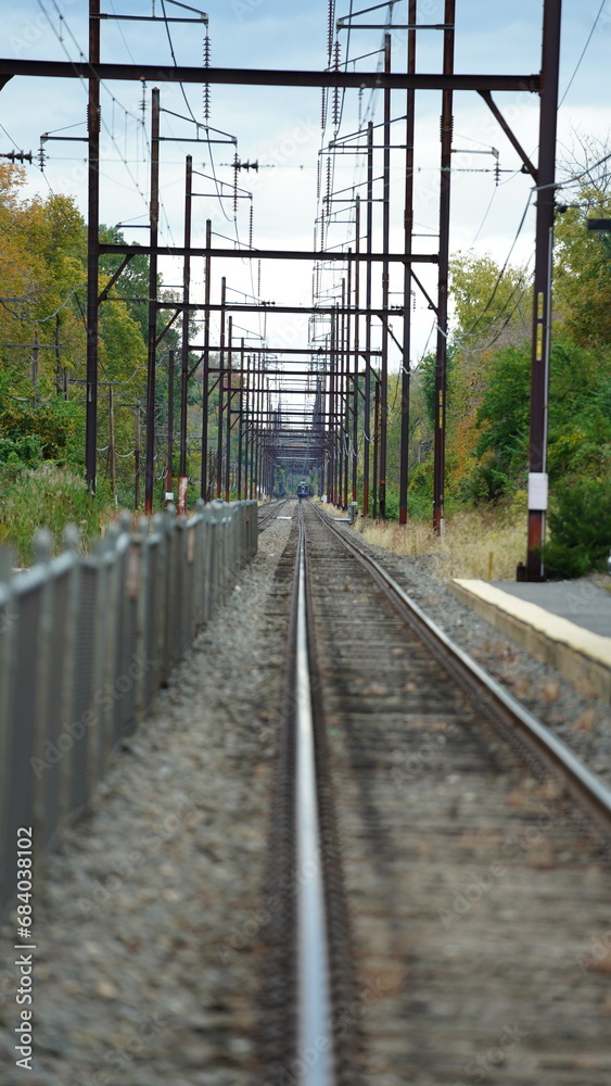 The railroad view with the parallel iron tracks and platform as background