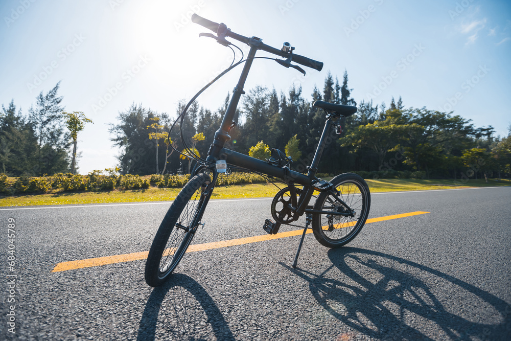 A folding bike on sunrise seaside road