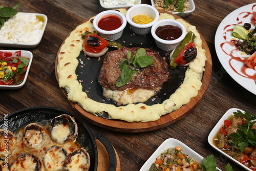 cooked red meat and various appetizers